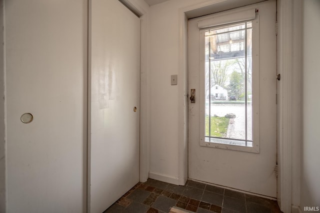 doorway to outside featuring stone finish flooring