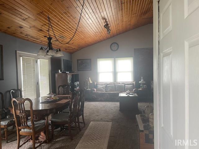 dining area featuring lofted ceiling, wooden ceiling, a notable chandelier, and carpet floors