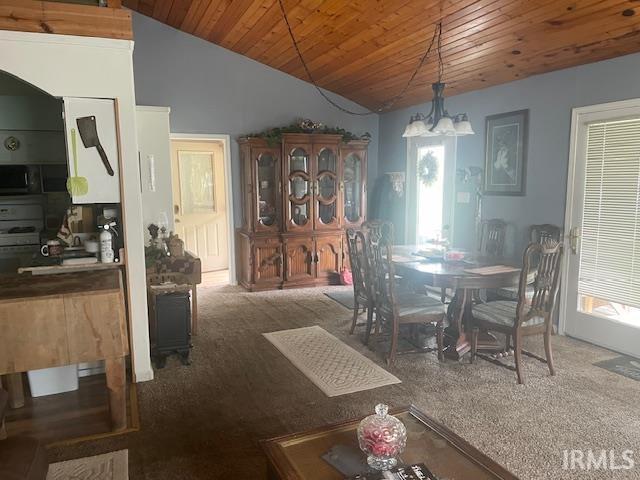 dining room with a chandelier, wooden ceiling, carpet, and vaulted ceiling