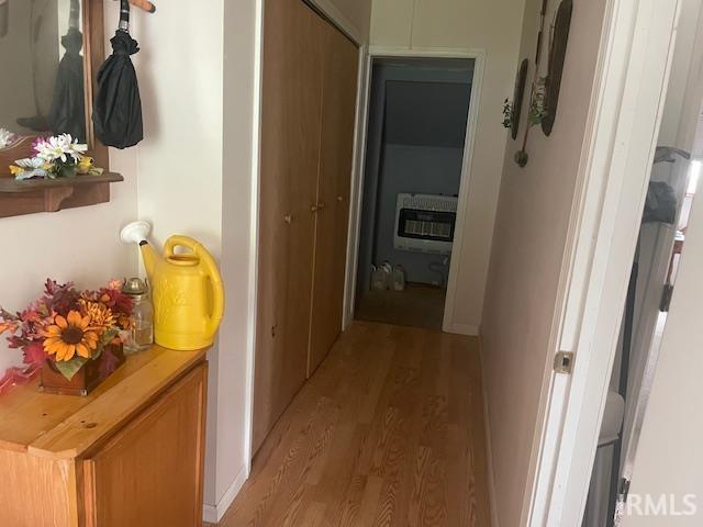 hallway featuring heating unit and light wood-type flooring