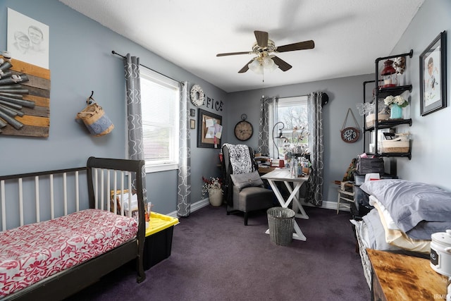 carpeted bedroom featuring baseboards and ceiling fan