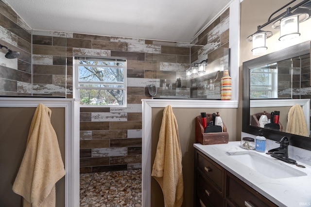 full bath featuring walk in shower and vanity