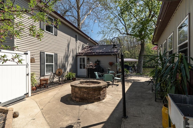 view of patio / terrace with fence and a fire pit