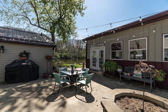view of patio with outdoor dining space, french doors, and area for grilling
