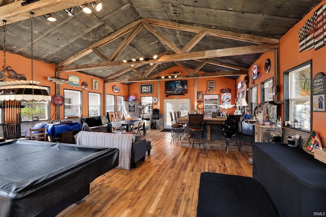 recreation room with hardwood / wood-style floors, a wealth of natural light, high vaulted ceiling, and pool table