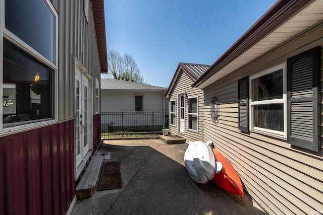 view of side of property featuring fence and a patio area
