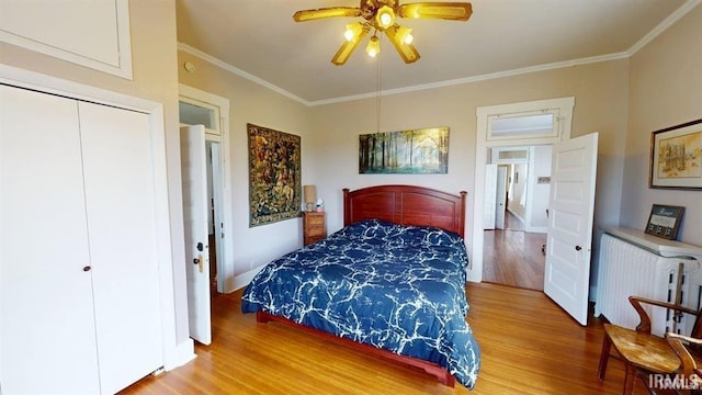 410 Riverside Dr, Jasper, IN 47546 - bedroom featuring wood finished floors, ornamental molding, radiator, a closet, and ceiling fan