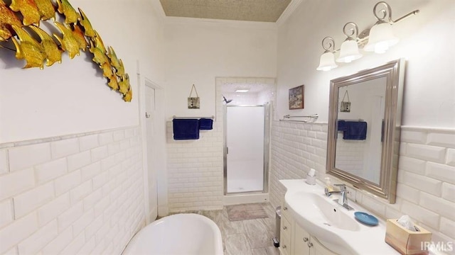 410 Riverside Dr, Jasper, IN 47546 - full bathroom featuring tile walls, a stall shower, crown molding, vanity, and wainscoting