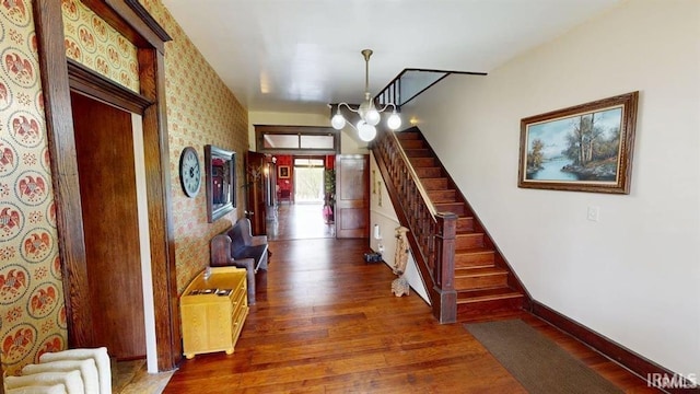 410 Riverside Dr, Jasper, IN 47546 - hallway featuring dark wood-style flooring, stairway, a chandelier, baseboards, and wallpapered walls