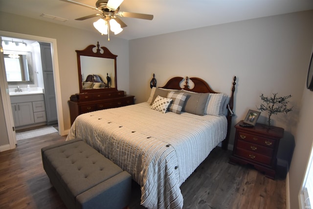 bedroom featuring wood finished floors, visible vents, ceiling fan, and a sink
