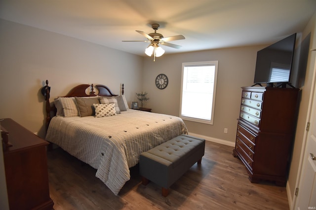 bedroom featuring ceiling fan, dark wood-style floors, and baseboards