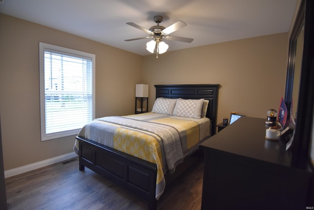 bedroom with a ceiling fan, dark wood-style floors, and baseboards