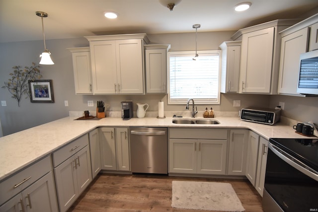 kitchen featuring stainless steel dishwasher, white microwave, a toaster, electric range, and a sink