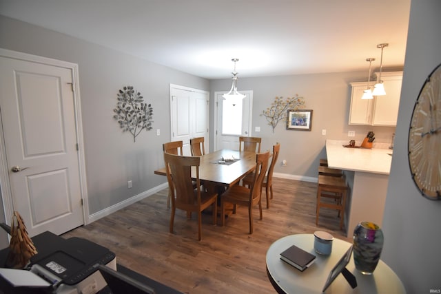 dining room featuring dark wood-style floors and baseboards