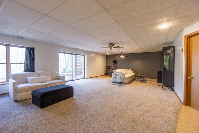 carpeted living area featuring a ceiling fan