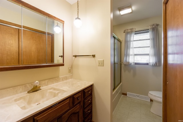 bathroom featuring tile patterned floors, toilet, vanity, baseboards, and visible vents