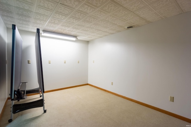 carpeted empty room with visible vents, an ornate ceiling, and baseboards