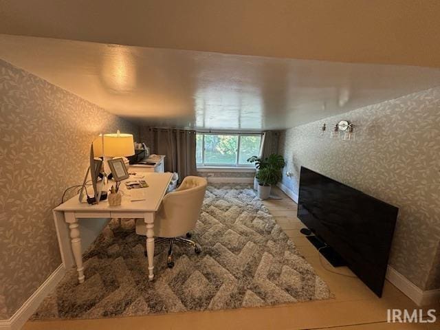 office space with wallpapered walls and baseboards