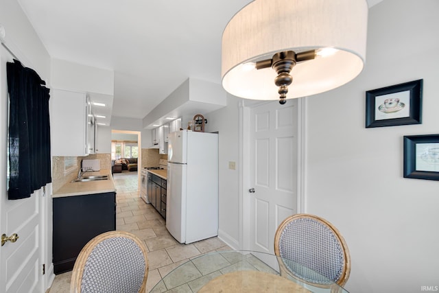 302 N Main St, Culver, IN 46511 - kitchen with freestanding refrigerator, a sink, light countertops, tasteful backsplash, and range with gas stovetop
