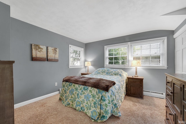 302 N Main St, Culver, IN 46511 - bedroom featuring a baseboard heating unit, light colored carpet, and baseboards