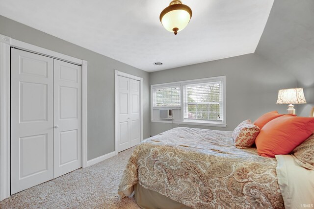 302 N Main St, Culver, IN 46511 - carpeted bedroom with multiple closets, baseboards, cooling unit, and vaulted ceiling