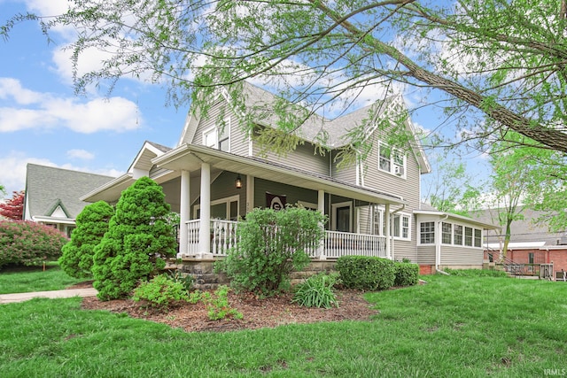 302 N Main St, Culver, IN 46511 - view of side of home with a porch, a yard, and a shingled roof
