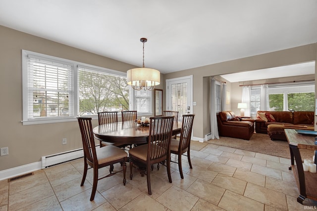 302 N Main St, Culver, IN 46511 - dining room featuring a chandelier, healthy amount of natural light, baseboards, and baseboard heating