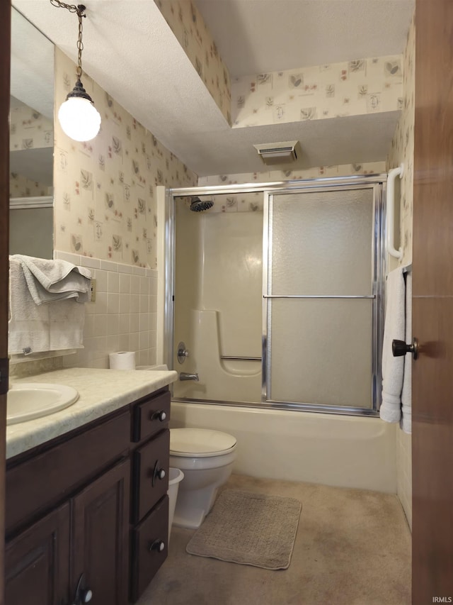 bathroom with wallpapered walls, wainscoting, shower / bath combination with glass door, vanity, and visible vents