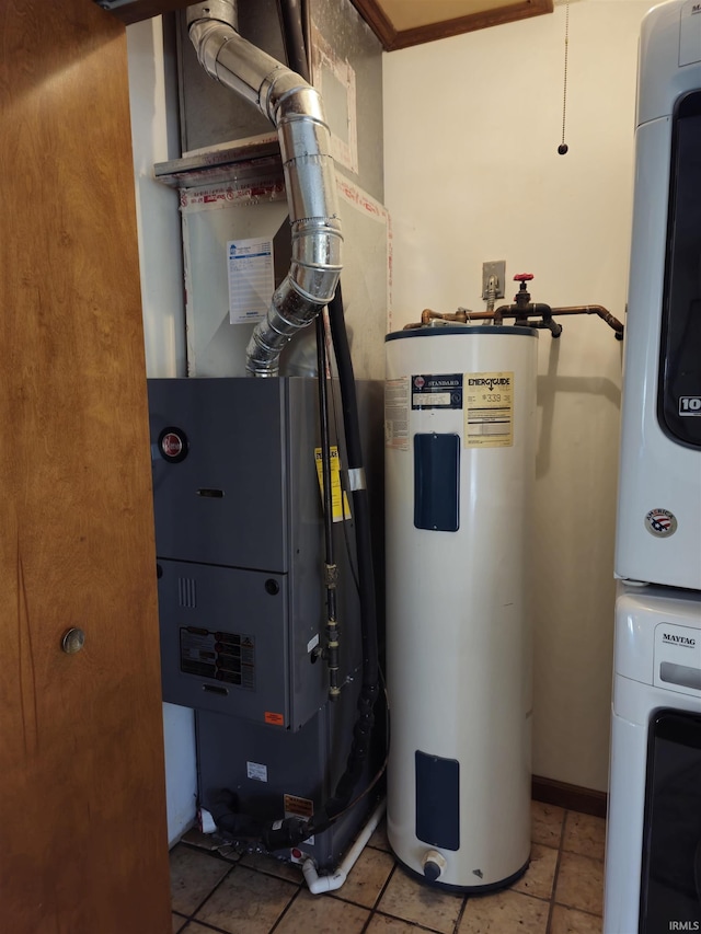 utilities with stacked washer and dryer, heating unit, and electric water heater