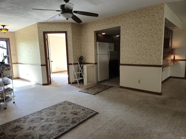carpeted living room featuring a ceiling fan, wallpapered walls, and baseboards
