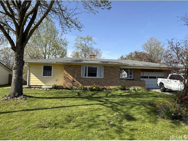 540 Fairfield Dr, Wabash, IN 46992 - ranch-style house featuring a chimney, brick siding, a front lawn, and an attached garage