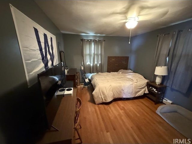 540 Fairfield Dr, Wabash, IN 46992 - bedroom featuring light wood-style floors, ceiling fan, and baseboard heating