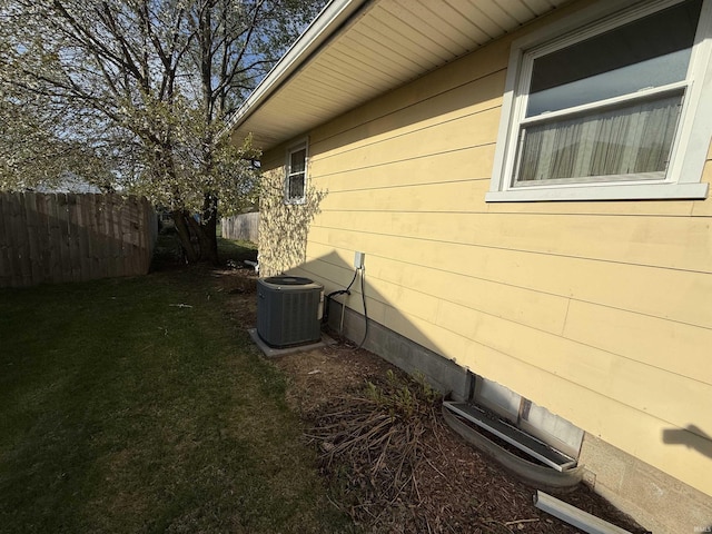 540 Fairfield Dr, Wabash, IN 46992 - view of side of home featuring fence, cooling unit, and a lawn