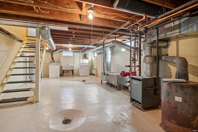 below grade area with stairway, washing machine and clothes dryer, a heating unit, and a sink