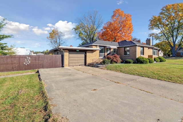 ranch-style home with brick siding, a chimney, concrete driveway, an attached garage, and fence