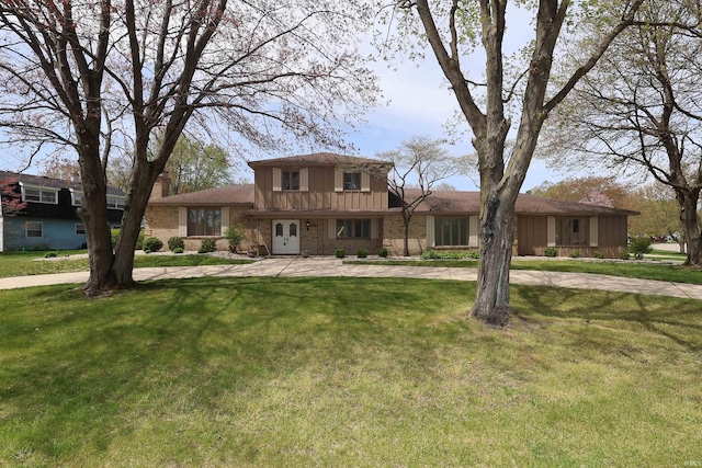 view of front facade featuring board and batten siding and a front yard