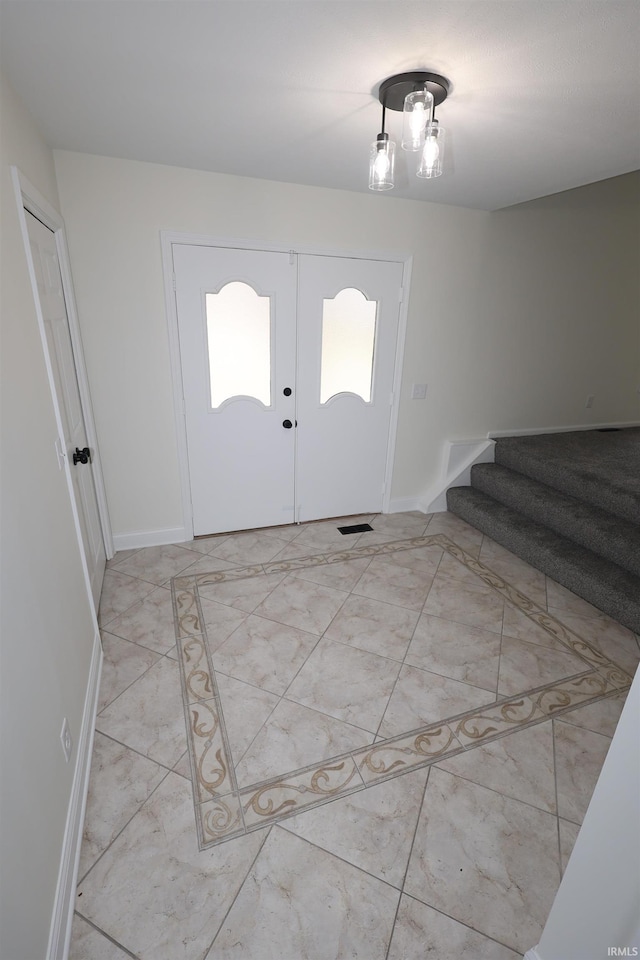 entryway featuring baseboards and stairs