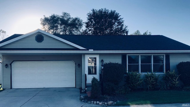 ranch-style home featuring an attached garage and concrete driveway