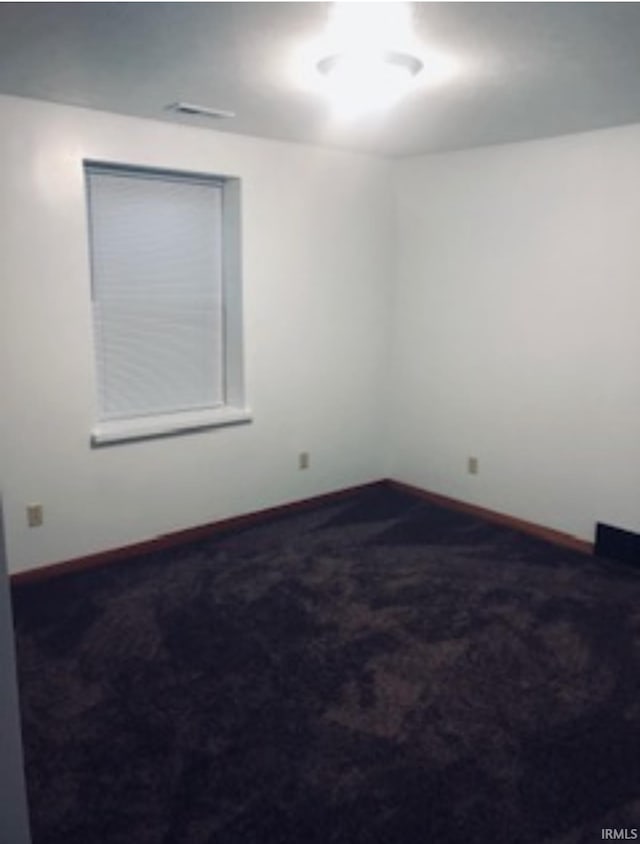 carpeted empty room with baseboards