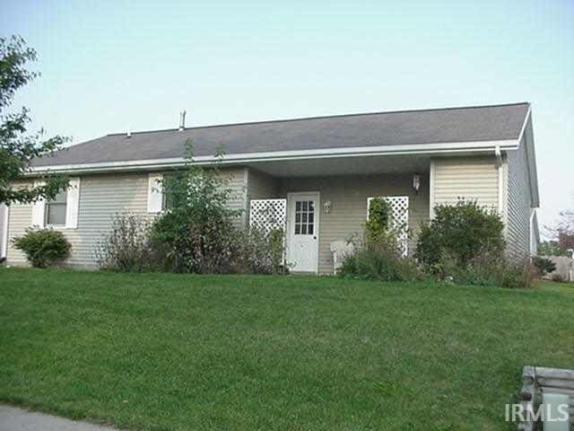 back of property featuring a yard