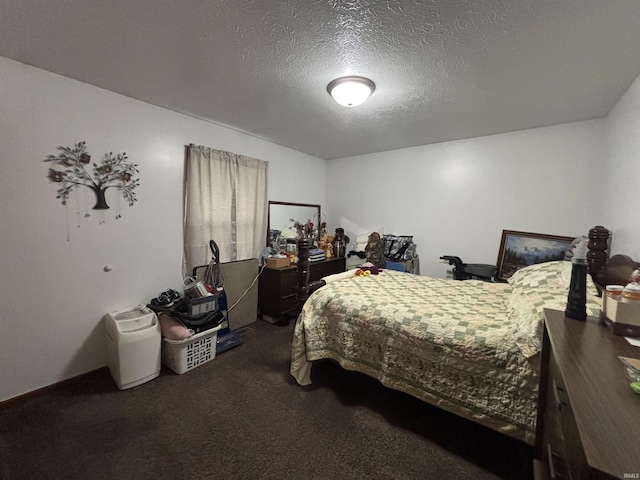 bedroom featuring carpet floors and a textured ceiling