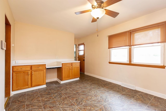 315 E Dean St, South Bend, IN 46614 - kitchen featuring baseboards, brown cabinetry, light countertops, and a ceiling fan