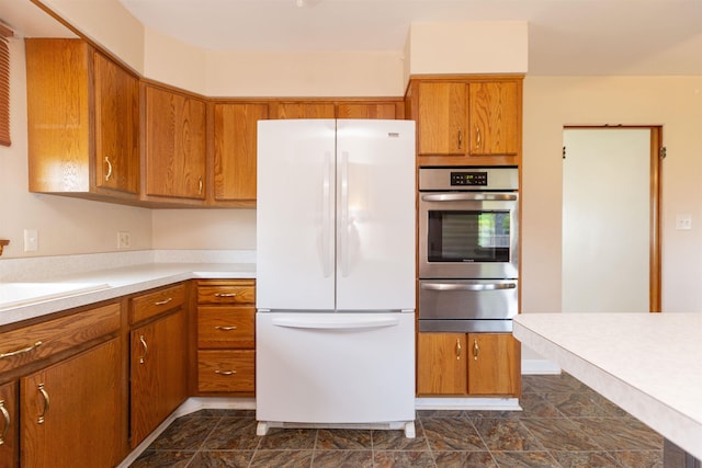 315 E Dean St, South Bend, IN 46614 - kitchen with freestanding refrigerator, oven, a warming drawer, brown cabinets, and light countertops