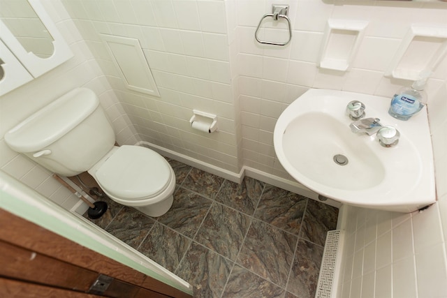 315 E Dean St, South Bend, IN 46614 - half bath featuring tile walls, toilet, a sink, and stone finish flooring