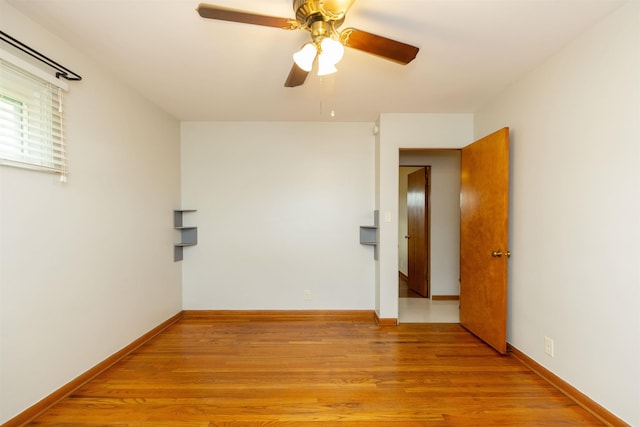 315 E Dean St, South Bend, IN 46614 - spare room with light wood-type flooring, ceiling fan, and baseboards