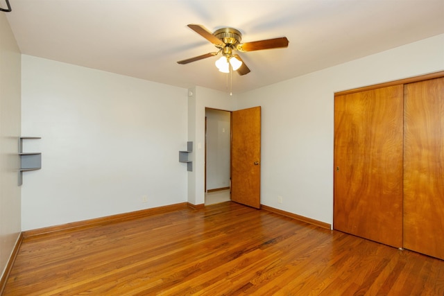 315 E Dean St, South Bend, IN 46614 - unfurnished bedroom with wood finished floors, a closet, baseboards, and ceiling fan
