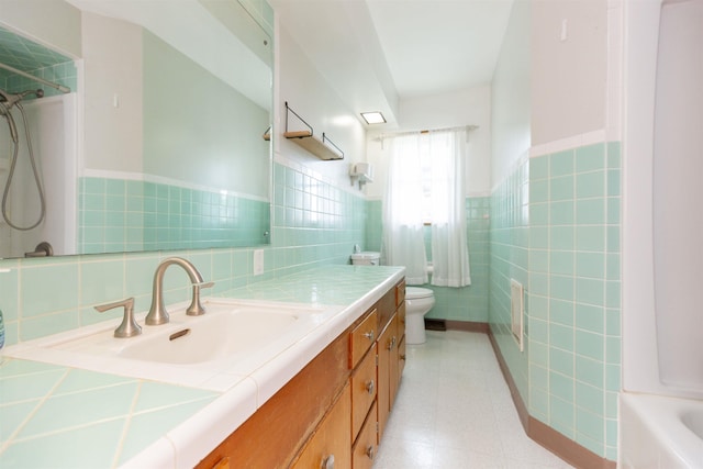 315 E Dean St, South Bend, IN 46614 - bathroom with tile walls, toilet, vanity, a wainscoted wall, and a shower