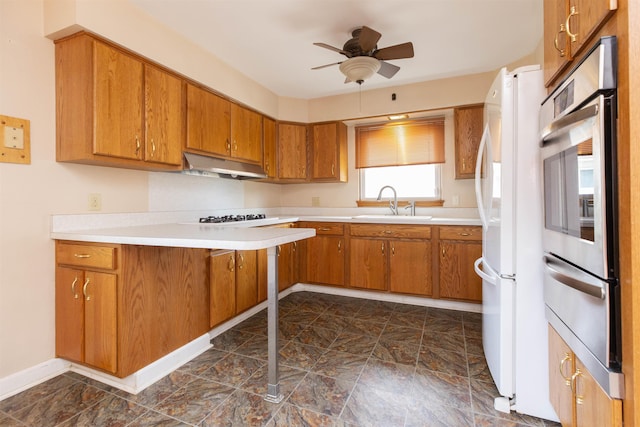 315 E Dean St, South Bend, IN 46614 - kitchen with under cabinet range hood, oven, a warming drawer, and brown cabinets