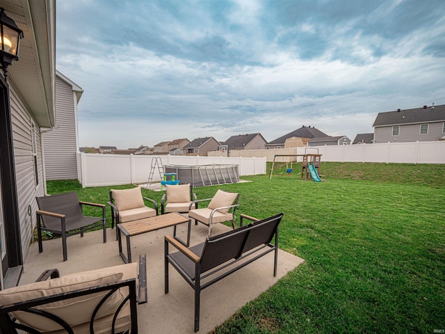 view of yard with a patio, a residential view, a playground, an outdoor living space, and a fenced backyard
