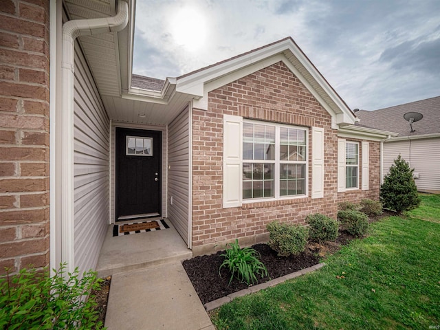 entrance to property featuring brick siding